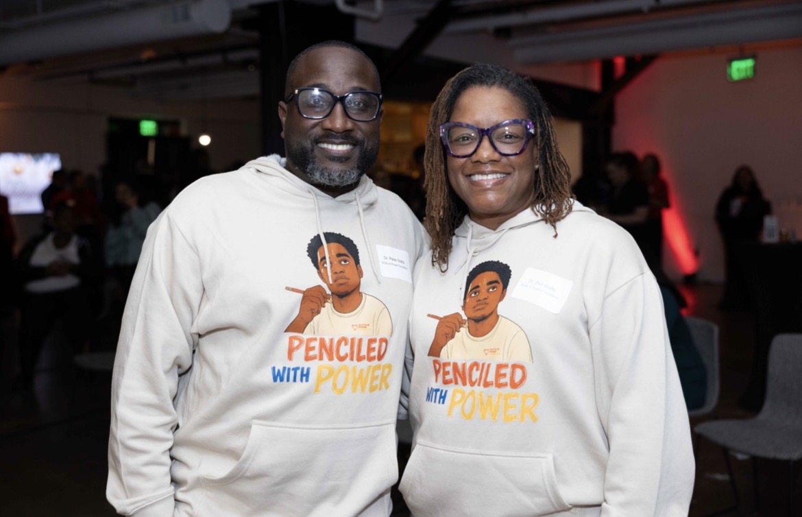 Dr. Peter Watts, Jr. and Dr. Didi Watts together wearing Penciled with Power sweatshirts.